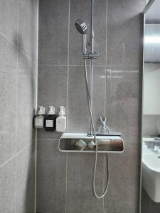 a shower in a bathroom with a sink at Stay Marina Ocean in Ansan