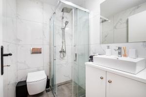 a bathroom with a shower and a toilet and a sink at Magical Brand New Suite in Zipárion