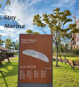 a sign in a park with a surfboard on it at Stay Marina Ocean in Ansan