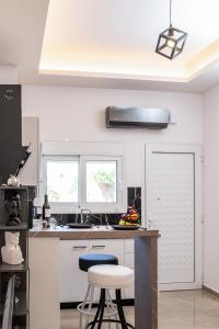 a kitchen with a sink and a counter with two windows at Magical Brand New Suite in Zipárion