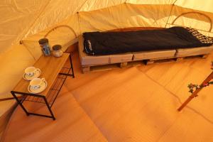 an overhead view of a tent with a bed and a table at Rescorla Retreats- Rose in St Austell