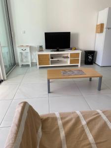 a living room with a tv and a coffee table at Appartement neuf 4pers. 250 mètres de la plage in Argelès-sur-Mer