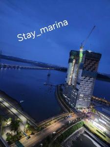 a skyline of a city with a large building and a bridge at Stay Marina Ocean in Ansan