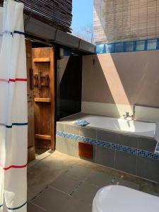 a bathroom with a tub and a sink and a toilet at Experience Island Heritage Home in Pantai Kok