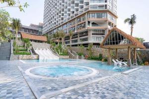 a swimming pool with a slide in a building at Bstudio in APEC Mandala Mũi Né in Phan Thiet