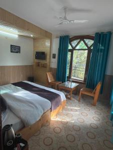 a bedroom with a bed and a large window at Calm Cottage KASAULI HILLS Barog in Barog