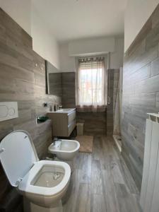 a bathroom with a toilet and a sink at Sole , Neve e Relax in Clusone