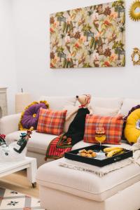 a living room with a couch with a tray of food at TRONCOSO ENEA in Zamora +35 photos