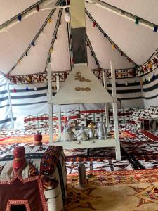 a room with a tent with a lot of items at كوخ المزرعة in Madain Saleh