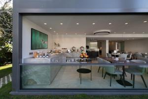 a large glass window of a house with a living room at Brasil Suites Boutique Hotel in Athens