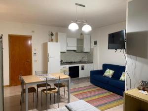 a living room with a table and a blue couch at House 417 Perugia in Perugia