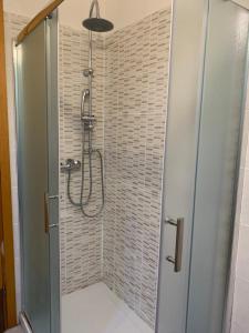 a shower with a glass door in a bathroom at House 417 Perugia in Perugia
