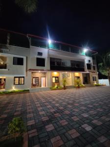 a building with a courtyard at night at HALF MOON HOMESTAY in Kalyānpur