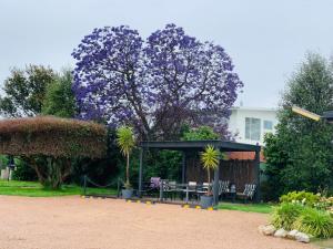 a gazebo with a table and chairs in a garden at Bairnsdale Town Central Motel in Bairnsdale