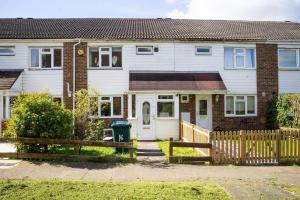 a house with a wooden fence in front of it at Modern 3 Bedroom house in Finchley in Totteridge