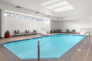 a swimming pool in a building with a large window at Courtyard by Marriott Minneapolis-St. Paul Airport in Mendota Heights