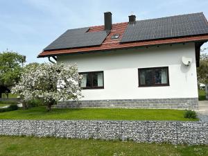 Haus Wiesenblick في Thurmansbang: منزل على السطح مع لوحات شمسية