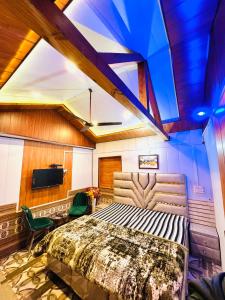 a bedroom with a bed and a tv in it at Exclusive Nagar Cottage in Mukteshwar