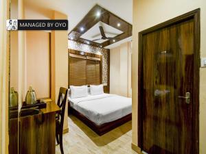 a bedroom with a bed and a wooden door at Townhouse Ballygunge Near Quest Mall in Ballygunge