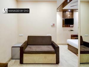 a bedroom with a couch and a bed in a room at Townhouse Ballygunge Near Quest Mall in Ballygunge