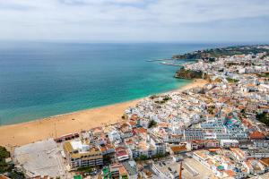 an aerial view of a beach and the ocean at Sandy Bottoms Hostel in Albufeira