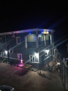 a blue building with lights on it at night at Paviosca Hotel in Umuahia