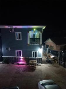 a house at night with a car parked in front of it at Paviosca Hotel in Umuahia