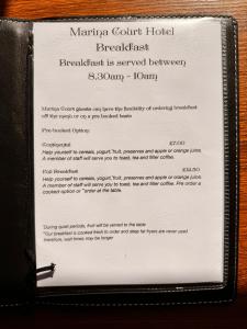 a menu for a restaurant in a black wallet at Marina Court in Weymouth