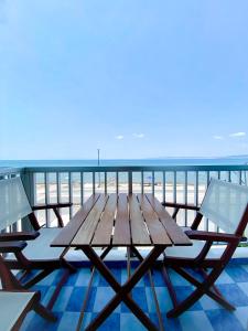 a wooden table and chairs on top of a balcony at Korali SeaView Apartment, Perea in Perea