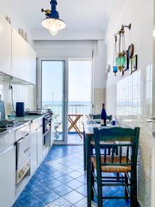 a kitchen with a table and a view of the ocean at Korali SeaView Apartment, Perea in Perea