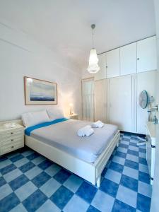 a bedroom with a bed and a blue and white floor at Korali SeaView Apartment, Perea in Perea +16 photos
