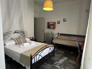 Postel nebo postele na pokoji v ubytování KIRIKOS ROOMS