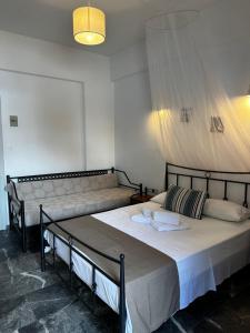Postel nebo postele na pokoji v ubytování KIRIKOS ROOMS