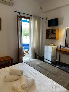 Postel nebo postele na pokoji v ubytování KIRIKOS ROOMS