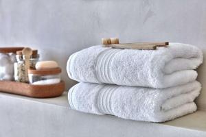 a stack of towels sitting on a shelf at Hotel Global Radiance plaza Delhi Airport in New Delhi