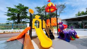 a playground with a yellow slide at Ocean Heart Hotel in Sigatoka