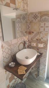 a bathroom with a sink and a mirror at B&B Le Vie del Borgo in Castiglione di Sicilia