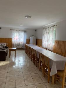 a large dining room with a long table and chairs at Casa de Vacanţă Vârtop in Vartop