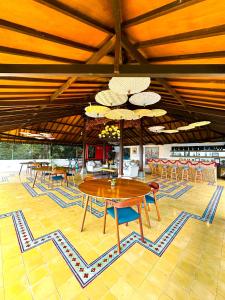 a dining room with tables and chairs in a building at Villa Borobudur Resort in Borobudur