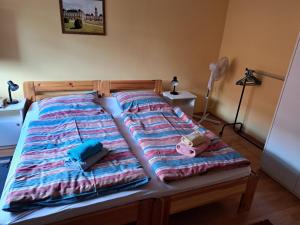 a bed with blankets and pillows on it at Balaton Beach Gyenesdiás in Gyenesdiás