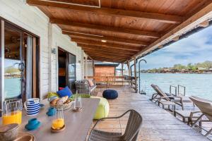 a porch with a table and chairs on a boat at Bel Assis in Ulcinj