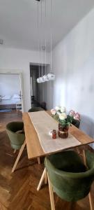 a wooden table with green chairs and a dining room at Apartment Eufemia in Kanfanar +6 photos