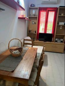 a dining room table with a basket on top of it at Glifa Beach House Maisonette in Glida