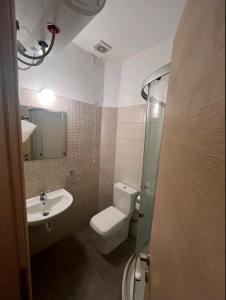 a bathroom with a toilet and a sink at Glifa Beach House Maisonette in Glida +20 photos