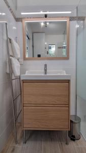 a bathroom with a sink and a mirror at "Côté Gibaou" Centre-ville Garage Piscine Terrasse in Cassis +19 photos