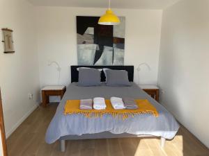 a bedroom with a bed with two towels on it at Le Lodge Park à La Rochelle in La Rochelle