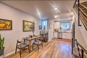 a dining room with a table and chairs and a kitchen at Modern South Philly Townhome in Philadelphia