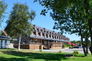 a hotel building with a large building at Hotel Cap-aux-Pierres in L'Isle-aux-Coudres