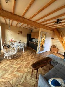 a living room with a wooden floor and a table at Na.Zadkach 