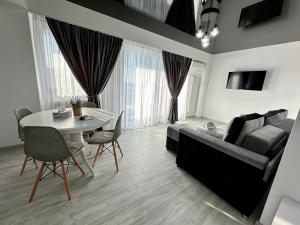 uma sala de estar com um sofá e uma mesa em CCD Seaview Apartments em Năvodari